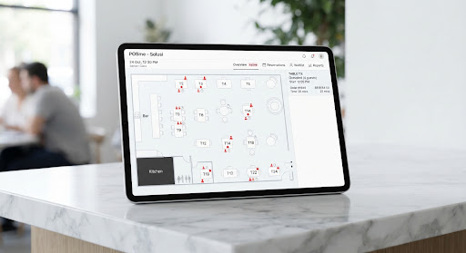 A clean, minimalist 3D mockup of an iPad displaying a modern restaurant table management interface. The screen shows a floor plan with clean lines and subtle red dot indicators for occupied tables. The tablet rests on a polished white marble surface in a bright, high-key lighting environment. The overall aesthetic is corporate, tech-forward, and entirely white-dominant with sharp black text and vivid red accents.